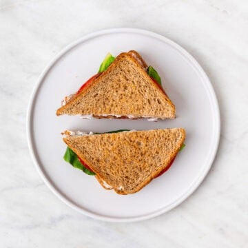Assembled Vegan BLT sandwich cut in half and ready to serve