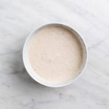 Creamy vegan broccoli salad dressing mixed in a small bowl
