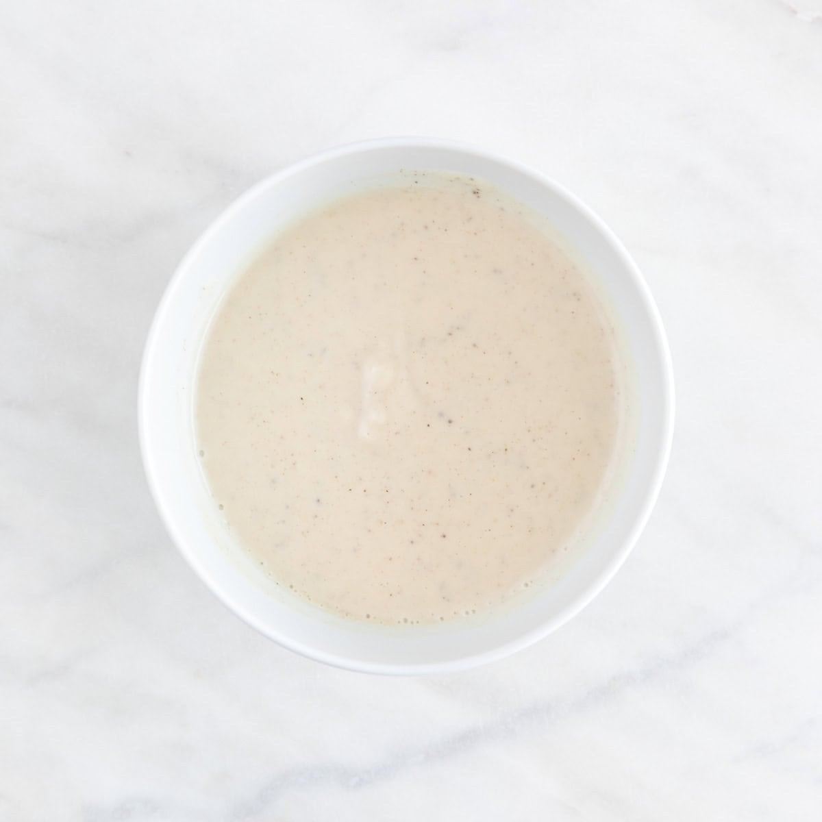 Vegan coleslaw dressing mixed in a small bowl