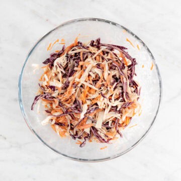 Vegan coleslaw mixed in a large bowl