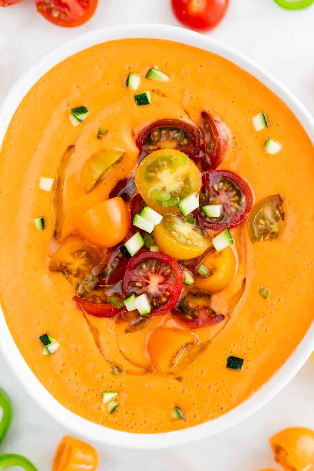 Cold Spanish gazpacho served with cherry tomatoes, cucumber, and extra virgin olive oil