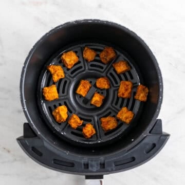 Crispy air-fried tofu in the air fryer basket