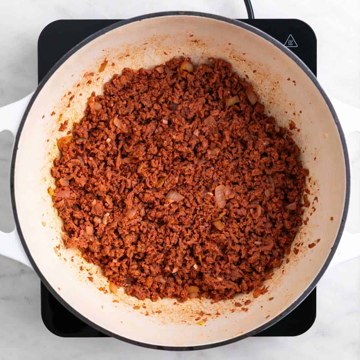 Vegan ground beef cooking with onion and garlic