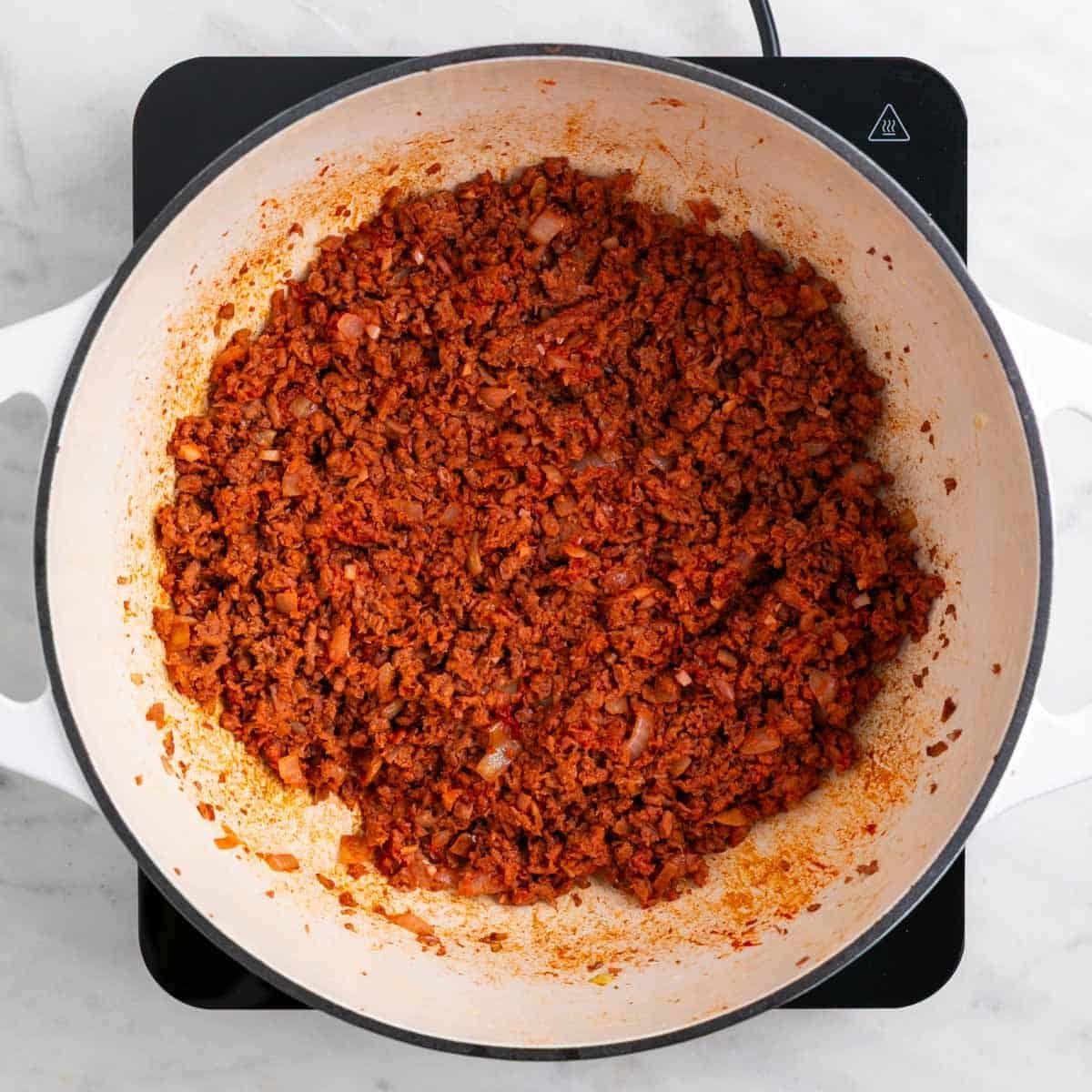 Tomato paste mixed into vegan ground beef