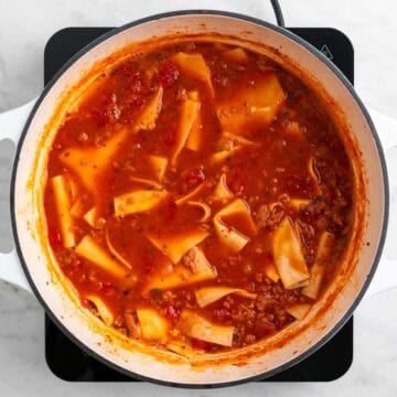 Broken lasagna noodles cooking in the soup
