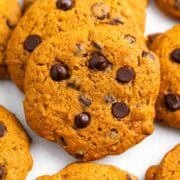Homemade pumpkin chocolate chip cookies displayed on a clean white background