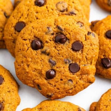 Homemade pumpkin chocolate chip cookies displayed on a clean white background