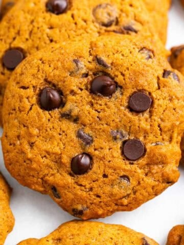 Homemade pumpkin chocolate chip cookies displayed on a clean white background