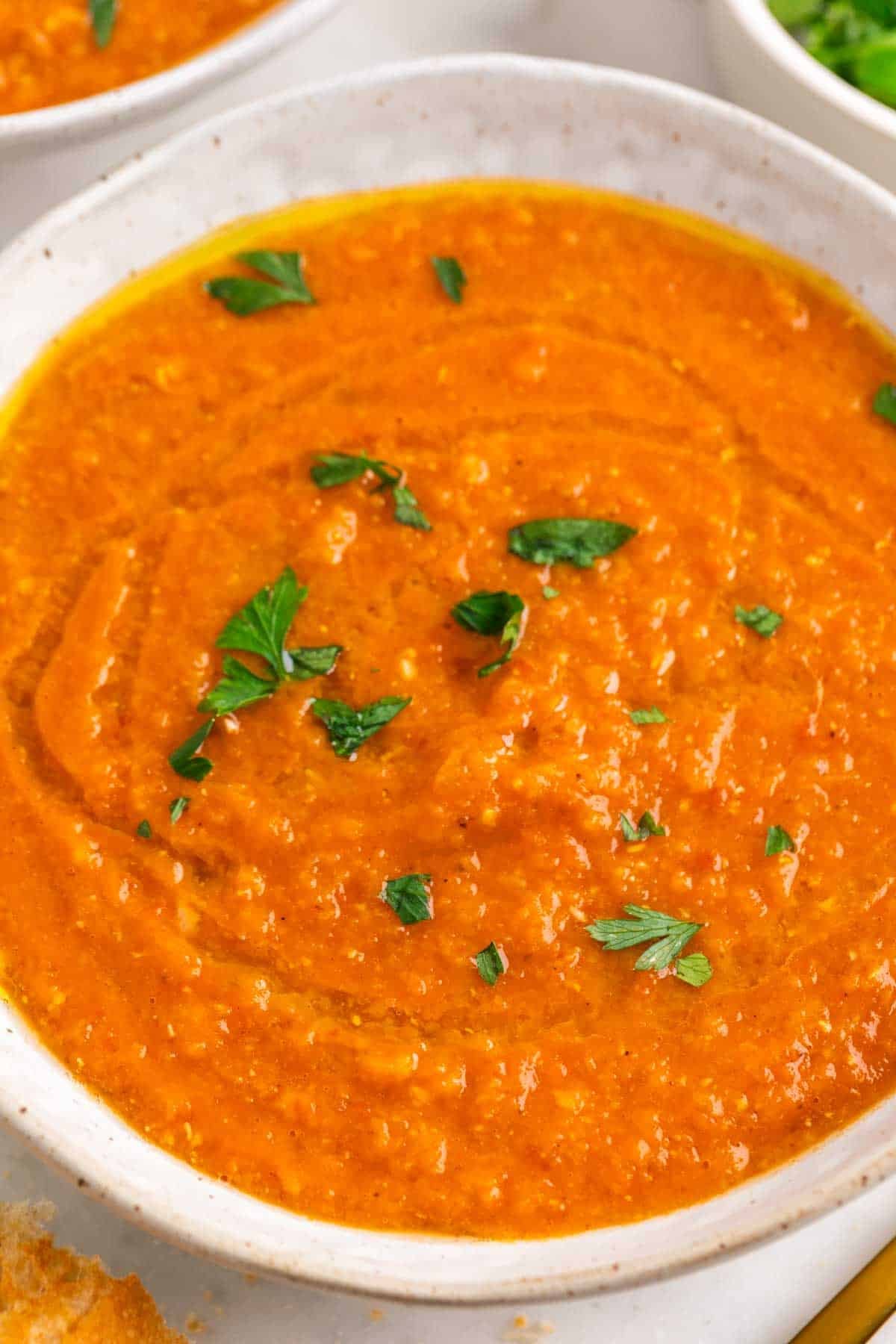 Red lentil soup topped with parsley and olive oil