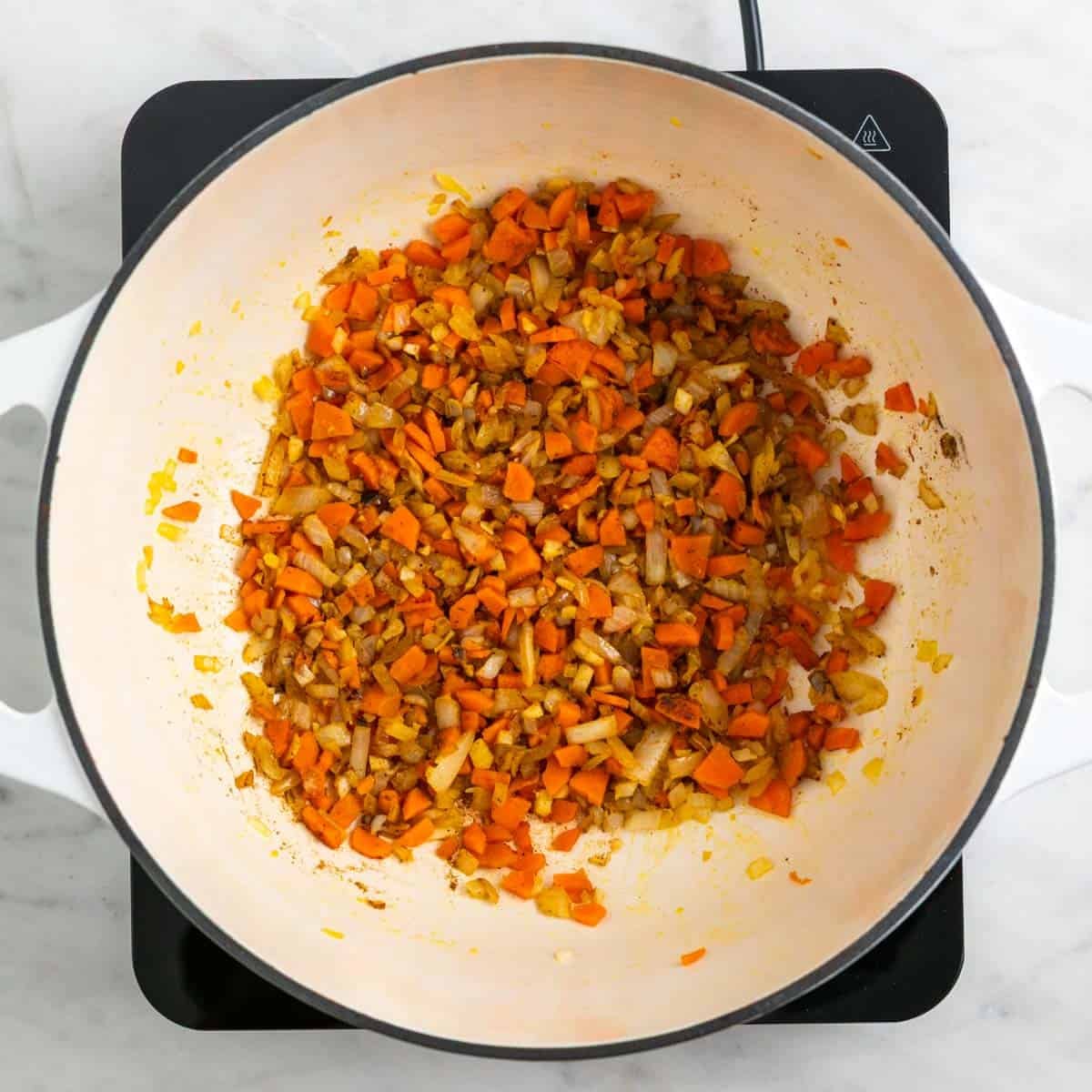 Spices added to the softened vegetables