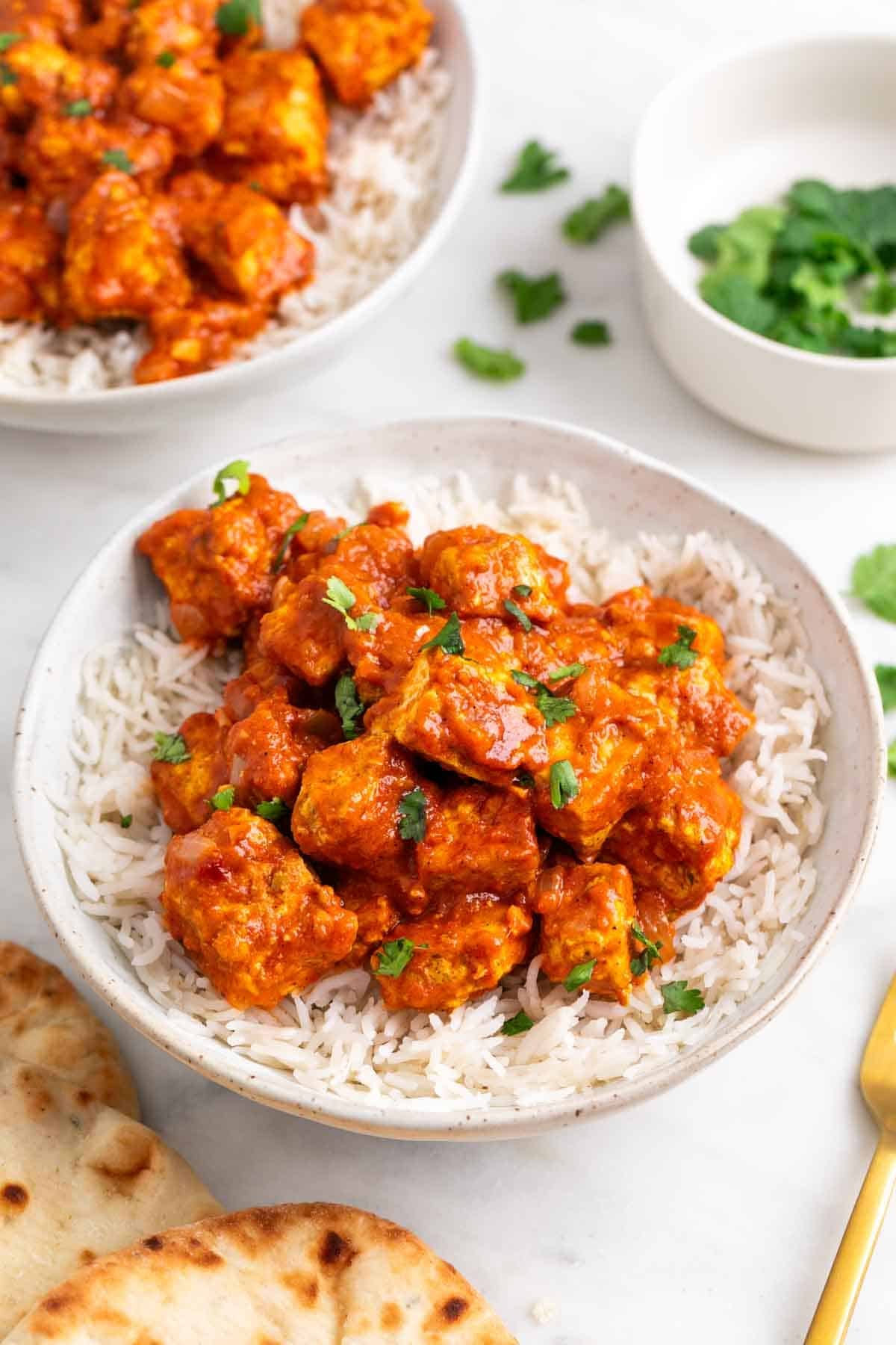 Tofu tikka masala served over basmati rice with fresh parsley