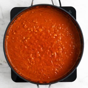 Coconut milk mixed into the tomato sauce