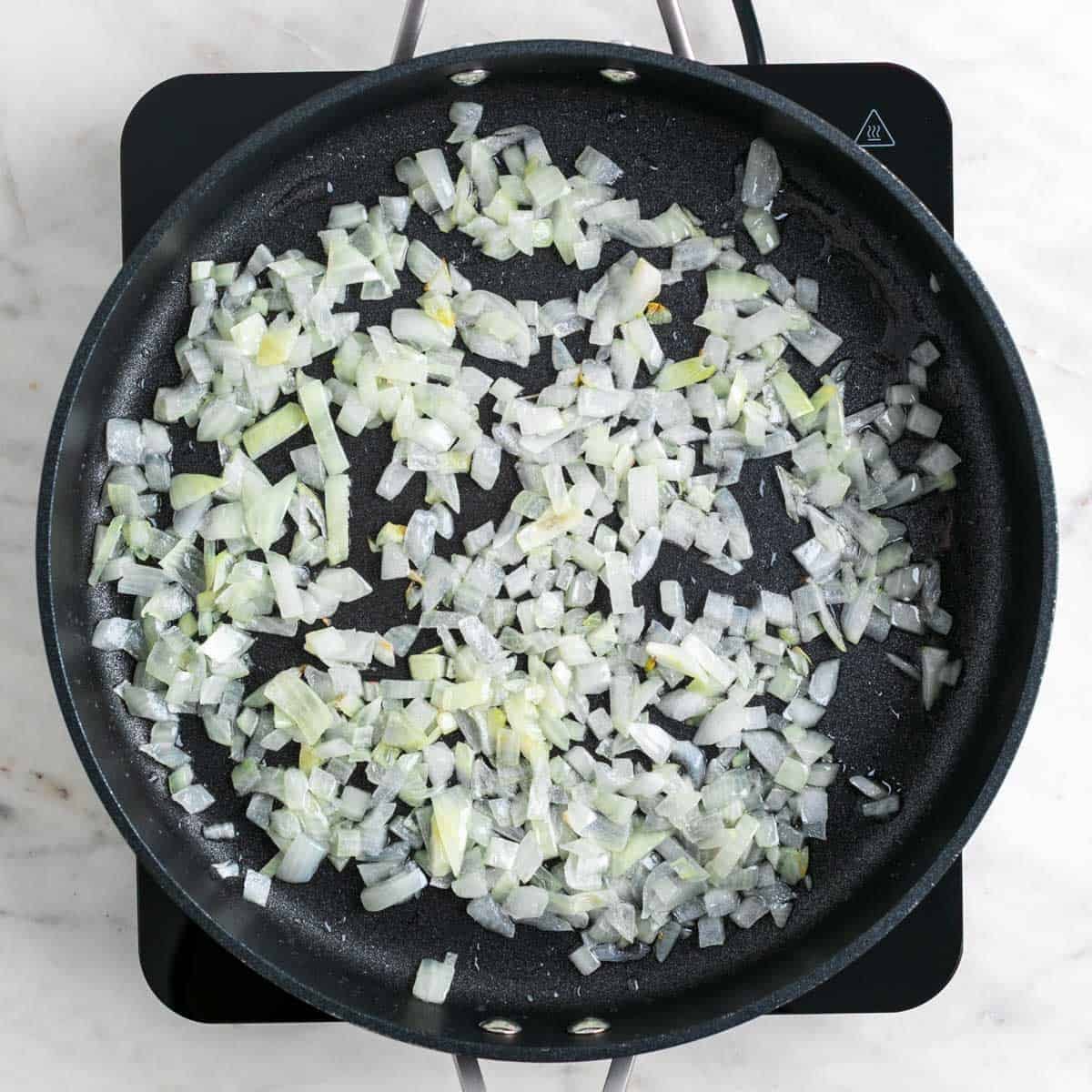 Chopped onion cooking in a skillet