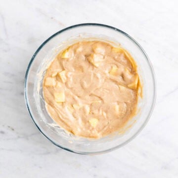 Diced apples folded into the batter