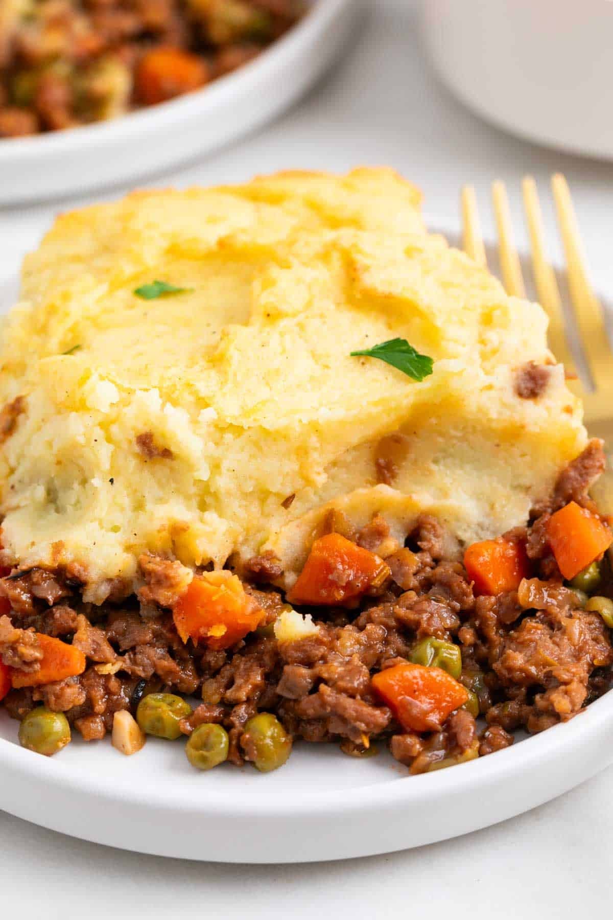 Vegan Shepherd's pie serving on a plate with a fork